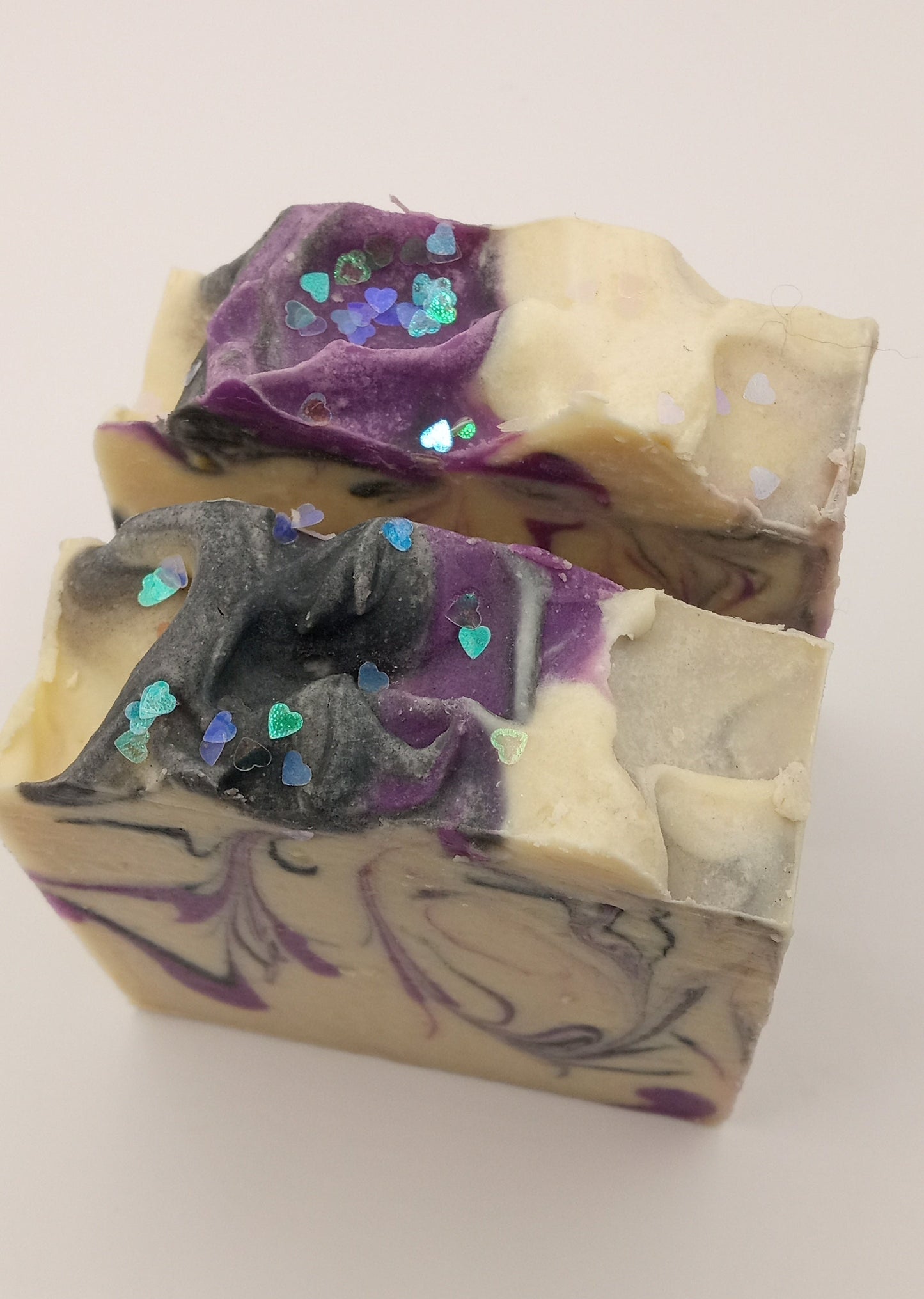 Handmade soap bar with purple and black swirl design