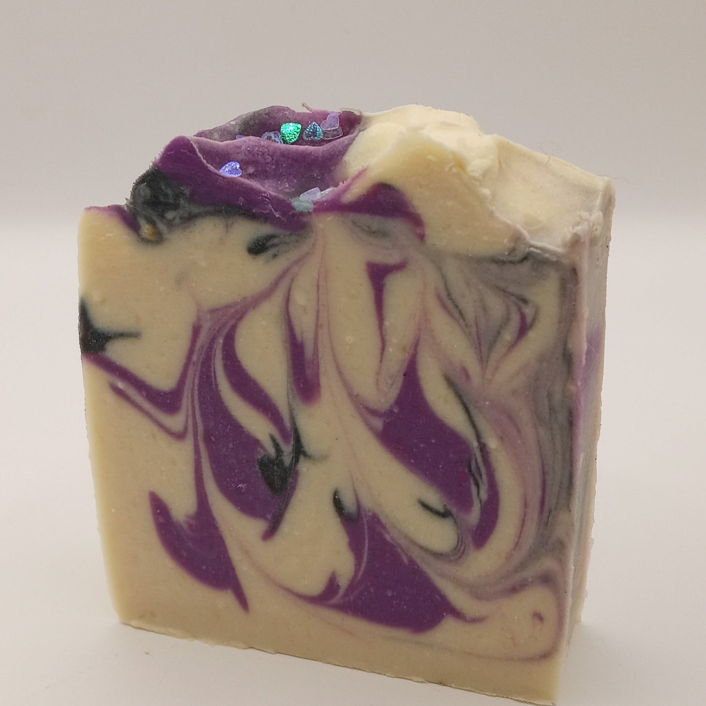 Black Raspberry Vanilla goat milk soap - swirled soap bar with purple and black, and eco glitter hearts on top